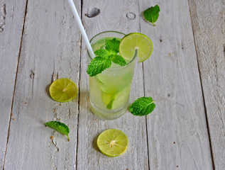 fresh juice with lime slice on wooden background