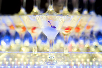 Cocktail with cherry and dry ice on dark background