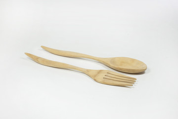 Wooden spoon and fork on white background