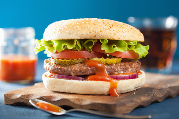 burger with beef patty lettuce onion tomato ketchup