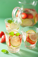 refreshing summer drink with strawberry cucumber lime in jar and