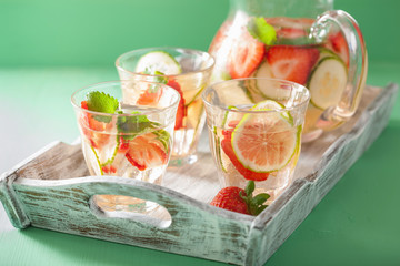 refreshing summer drink with strawberry cucumber lime in jar and