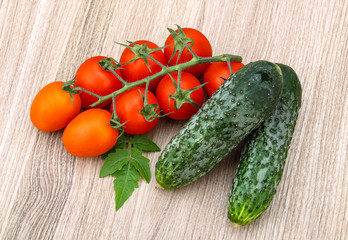 Cucumbers and tomatoes on the branch