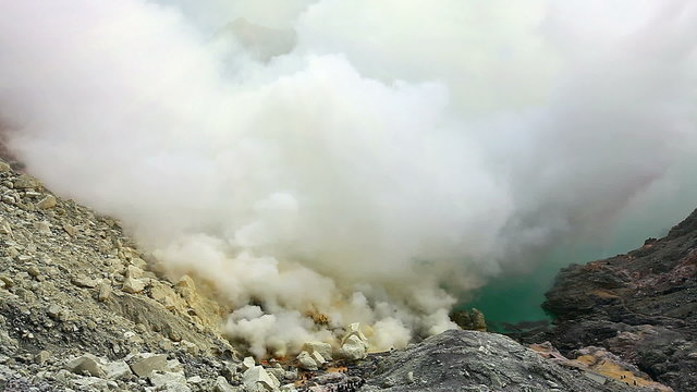Panoramic view from the top of Ijen crater on sulfur mine and acid crater lake. East Java, Indonesia.