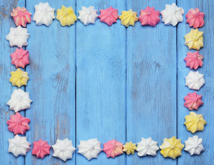 French vanilla meringue cookies on blue background.