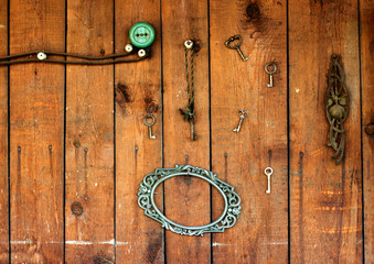 vintage frame and key on wooden wall with power outlet