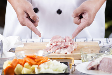 Obraz na płótnie Canvas Chef present raw pork on wooden board