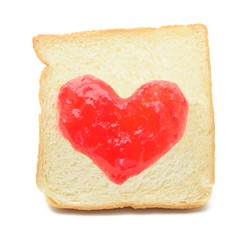 Jam heart drawn on a piece of bread.