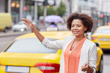 happy african woman catching taxi