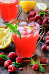 Homemade lemonade with fresh lemon, raspberries and mint served with ice