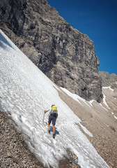 Male hiker on a snow field at Hochvogel Mountain