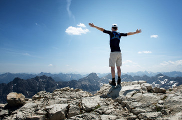 Rear View of Male Hiker on Top of Mountain