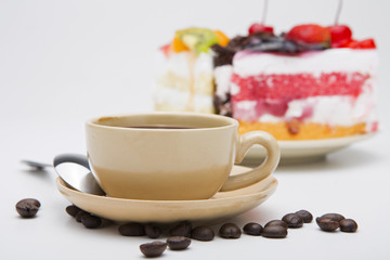 cup of coffee and delicious cake on white background