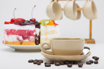 cup of coffee and delicious cake on white background