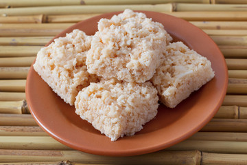 Coconut candy cocada on brown plate