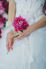 Bride holding the peony flower