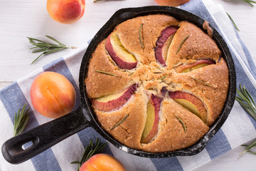 Homemade pie with peaches, apricots and rosemary