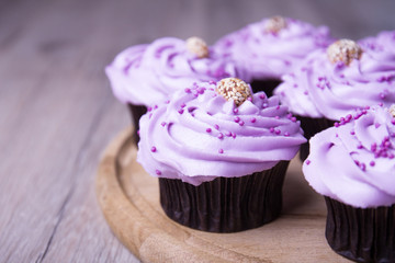Purple cupcakes on a board