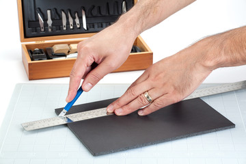 Hands cutting on board with sharp knife