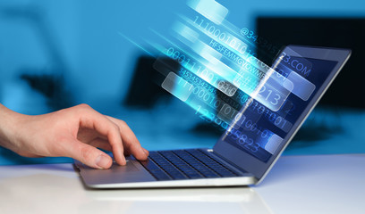 Close up of man typing on laptop computer