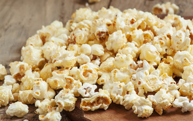 Sweet caramel popcorn in a wooden bowl, selective focus