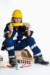 Smiling girl with helmet and work the drill