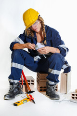 Smiling girl with helmet and work the drill