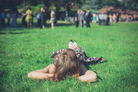 Woman relaxing on grass at party