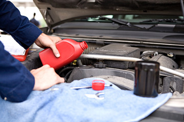 Mechanic: Pouring Oil Into Engine