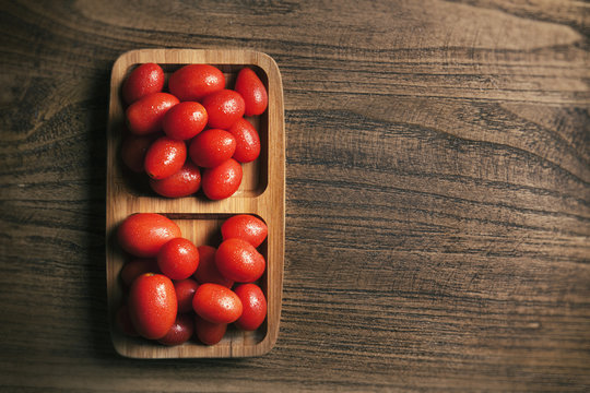 Top view of cherry tomatoes on the wooden texture table
