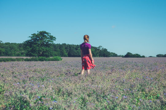 Woman standing in field of purple flowers