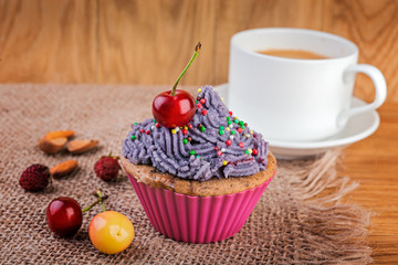  Cupcake and cup of coffee decorated with berries and wild flowers
