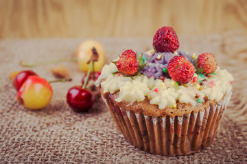  Cupcakes  decorated with berries and wild flowers