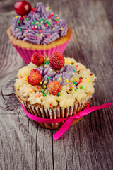  Cupcakes  decorated with berries and wild flowers