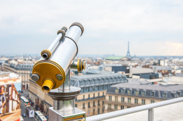 Tourist telescope over Paris landscape on Lafayette Gallery terrace