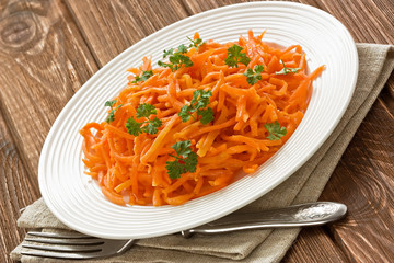 Carrot salad / Carrot salad with parsley leaves on rustic wooden background