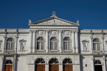 Fototapeta na wymiar White classical style theatre in Plaza Arturo Prat in the old quarter of Iquique on the Pacific coast of northern Chile.