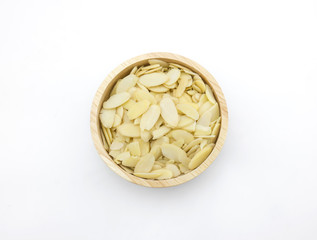 Almond slices in wooden bowl on white background