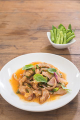 spicy sliced pork salad, NamTok, thai food on wooden table