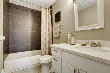 Simplistic bathroom wth grey and white theme.