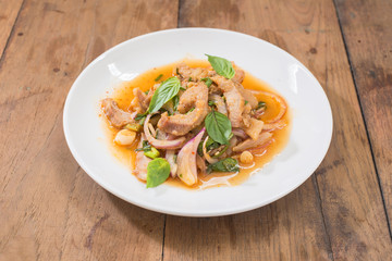 spicy sliced pork salad, NamTok, thai food on wooden table