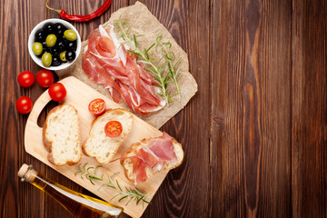 Bruschetta ingredients - prosciutto, olives, tomatoes