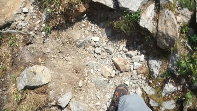 Hiker climbs up a mountain. Hikers point of view.