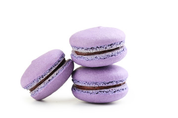 Tasty purple macarons isolated on white