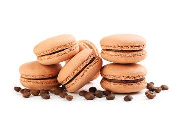 Tasty coffee macarons with coffee beans isolated on white