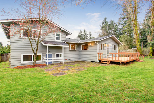 Lovely Back Yard With Deck And Grass.