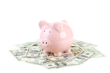 Pink piggy bank on dollars isolated on a white