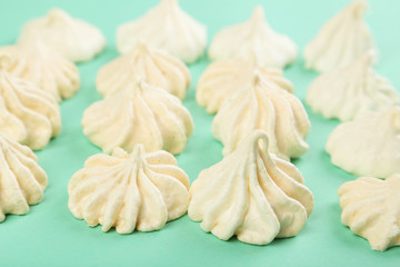 French meringue cookies on green background