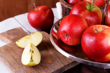 Tasty ripe apples on serving tray on table close up