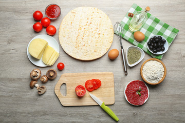 Ingredients for cooking pizza on wooden table, top view